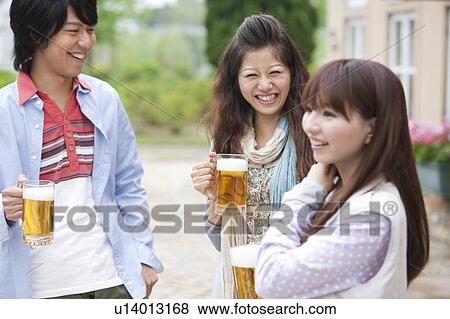Young people drinking beer outdoors View Large Photo Image Stock Photo - Young people drinking beer outdoors. Fotosearch