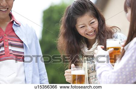 Young people drinking beer outdoors View Large Photo Image Stock Photograph - Young people drinking beer outdoors. Fotosearch