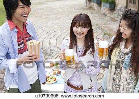Young people drinking beer outdoors View Large Photo Image Stock Photograph - Young people drinking beer outdoors. Fotosearch