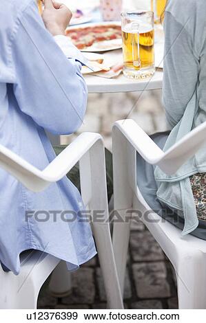 Young people eating at an outdoor cafe View Large Photo Image Stock Photo - Young people eating at an outdoor cafe. Fotosearch