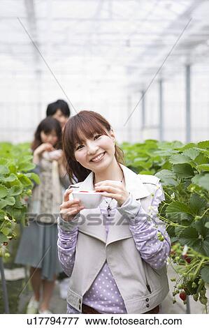 Young people eating strawberries View Large Photo Image Stock Photo - Young people eating strawberries. Fotosearch