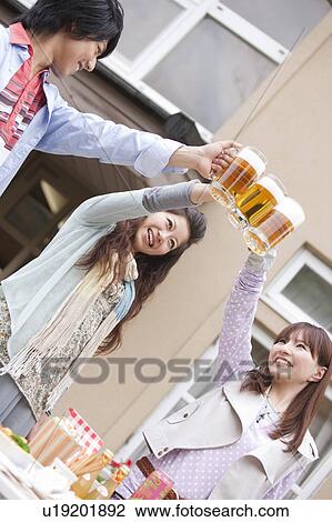 Young people toasting with beer View Large Photo Image Stock Image - Young people toasting with beer. Fotosearch