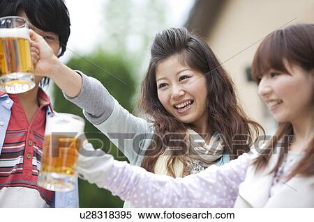 Young people toasting with beer View Large Photo Image Stock Photography - Young people toasting with beer. Fotosearch