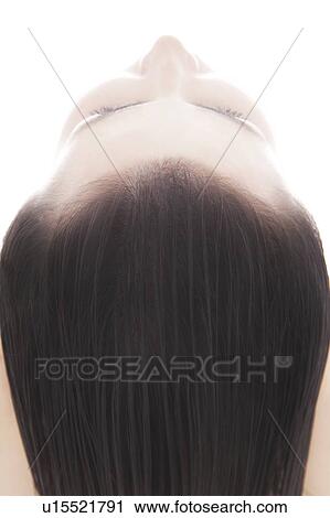 Stock Image - Young woman and her hair. Fotosearch