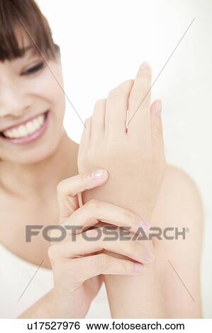 Young Woman Applying Hand Cream View Large Photo Image Stock Photograph - Young Woman Applying Hand Cream. Fotosearch