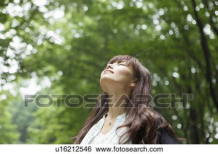 Stock Photograph - Young Woman Breathing Fresh Air. Fotosearch