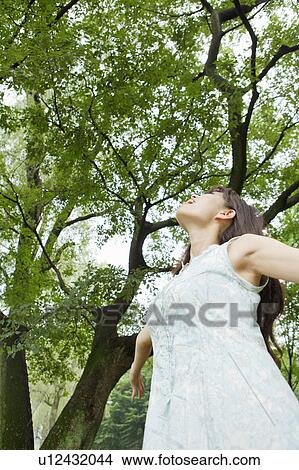 Picture - Young Woman Breathing in Fresh Air. Fotosearch