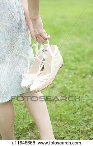 Young Woman Carrying Shoes View Large Photo Image Stock Photo - Young Woman Carrying Shoes. Fotosearch
