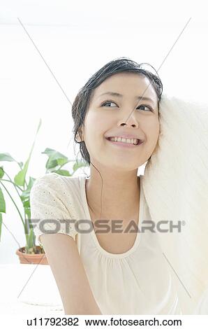 Stock Image - Young Woman Drying Her Face. Fotosearch
