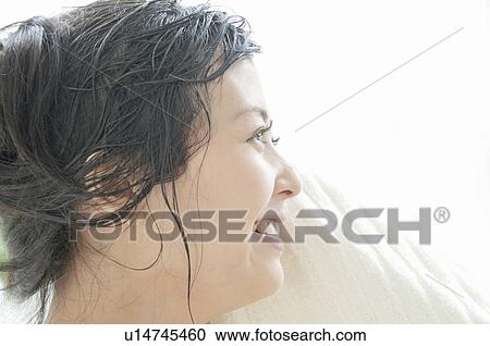 Stock Image - Young Woman Drying Her Face. Fotosearch