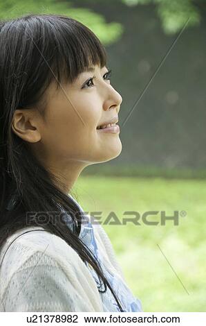 Stock Image - Young Woman Enjoying Herself Outdoors. Fotosearch