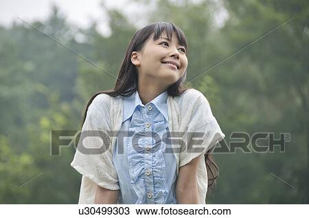 Stock Image - Young Woman Enjoying Herself Outdoors. Fotosearch