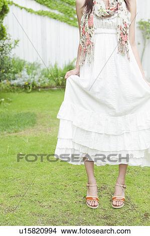 Picture - Young Woman Holding Dress. Fotosearch
