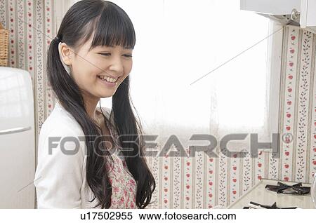 Young Woman in Kitchen View Large Photo Image Stock Photography - Young Woman in Kitchen. Fotosearch