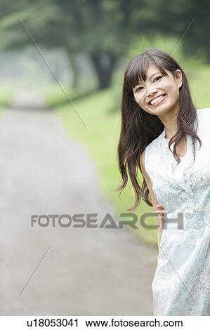 Stock Image - Young Woman in Park. Fotosearch