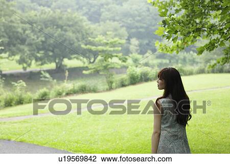 Stock Image - Young Woman in Park. Fotosearch