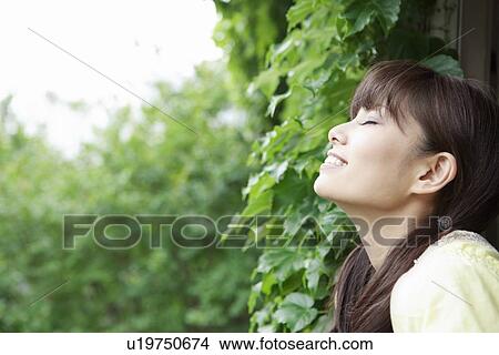 Picture - Young Woman Inhaling Fresh Air. Fotosearch