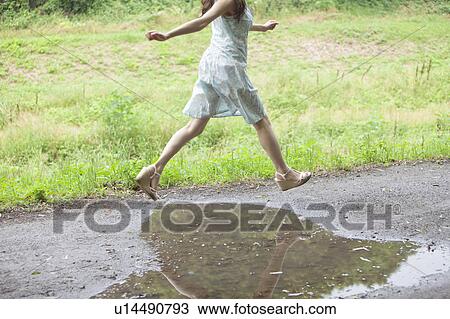 Stock Image - Young Woman Leaping. Fotosearch