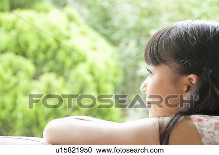 Stock Image - Young Woman Looking at View. Fotosearch