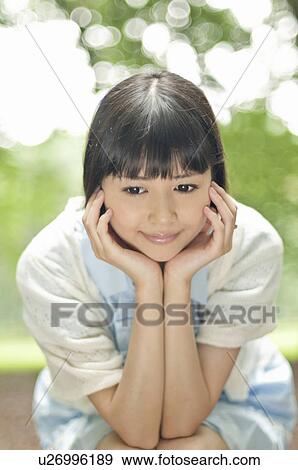 Stock Photo - Young Woman Looking Down. Fotosearch