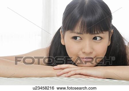 Stock Photograph - Young Woman Looking Sideways. Fotosearch