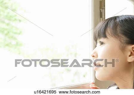 Stock Photography - Young Woman Looking Through Window. Fotosearch