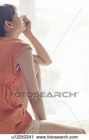 Stock Image - Young Woman Looking Up. Fotosearch