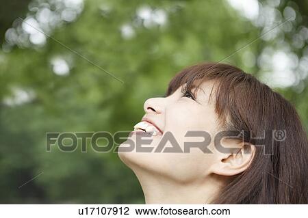 Stock Image - Young Woman Looking Up. Fotosearch