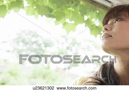 Stock Image - Young Woman Looking Up. Fotosearch