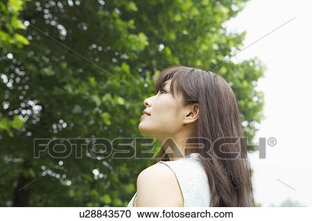 Stock Image - Young Woman Looking Up. Fotosearch