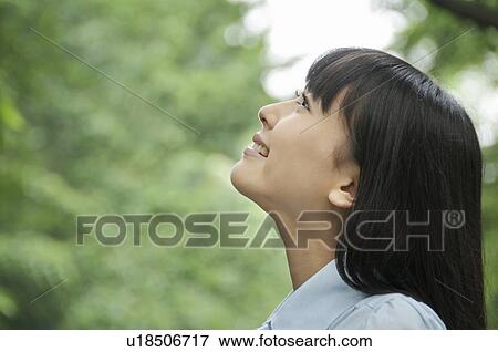 Stock Photo - Young Woman Looking Up. Fotosearch