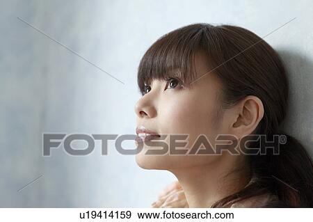 Stock Photo - Young Woman Looking Up. Fotosearch