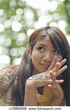 Stock Photo - Young Woman Looking Up. Fotosearch
