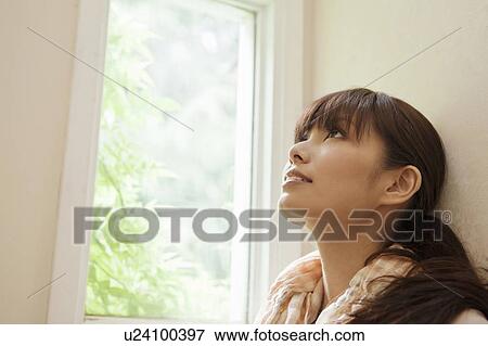 Stock Photo - Young Woman Looking Up. Fotosearch