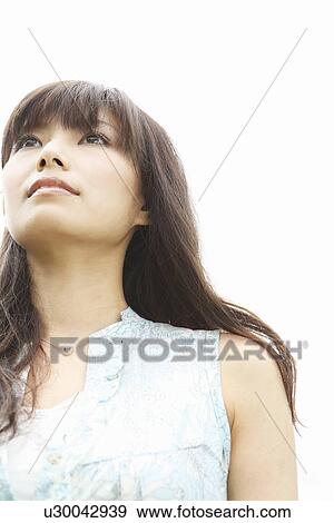 Stock Photo - Young Woman Looking Up. Fotosearch