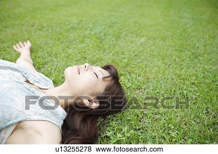 Young Woman on Grass View Large Photo Image Stock Photo - Young Woman on Grass. Fotosearch