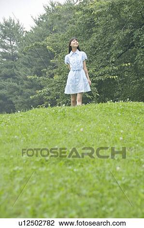 Stock Image - Young Woman on Hill. Fotosearch