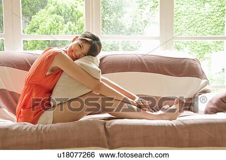 Young Woman on Sofa View Large Photo Image Stock Photograph - Young Woman on Sofa. Fotosearch