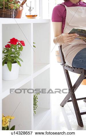 Young woman reading a book View Large Photo Image Stock Photo - Young woman reading a book. Fotosearch