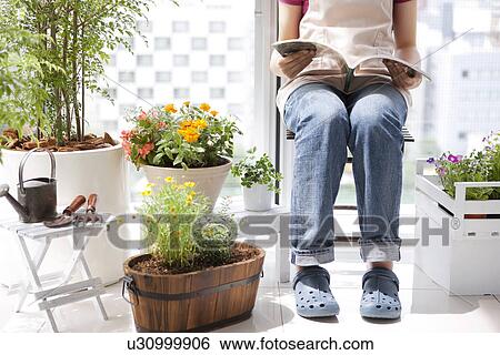 Stock Photograph - Young woman reading a book. Fotosearch