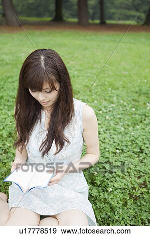 Young Woman Reading Book in Park View Large Photo Image Stock Photo - Young Woman Reading Book in Park. Fotosearch