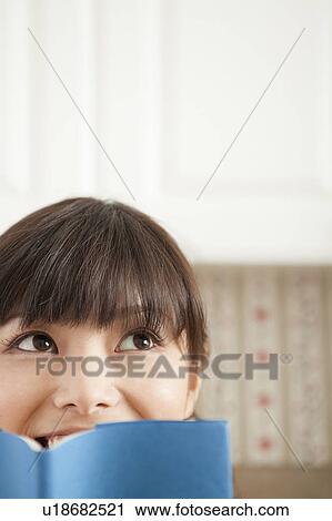 Stock Image - Young Woman Reading Book. Fotosearch