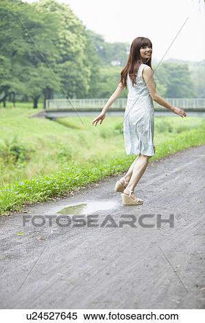 Stock Photography - Young Woman Running on Footpath. Fotosearch