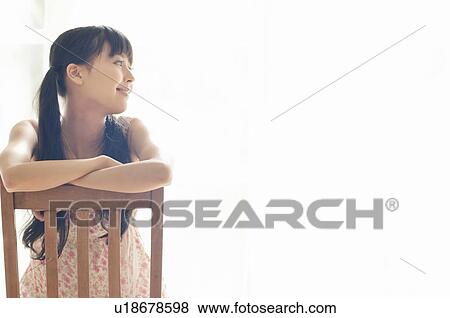 Young Woman Sitting on Chair View Large Photo Image Stock Photo - Young Woman Sitting on Chair. Fotosearch