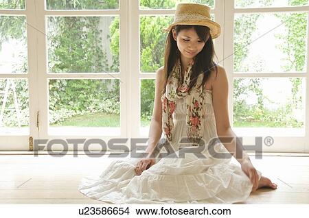 Picture - Young Woman Sitting on Floor. Fotosearch