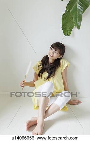 Stock Photograph - Young Woman Sitting on Floor. Fotosearch