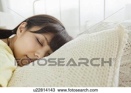 Stock Image - Young Woman Sleeping. Fotosearch