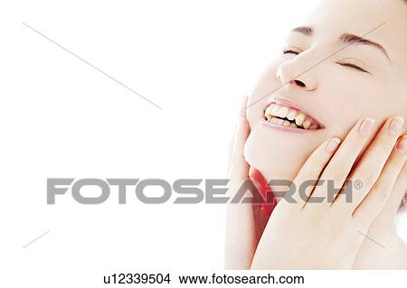 Picture - Young woman touching face. Fotosearch