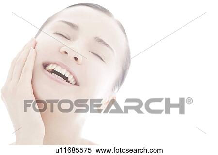 Young woman touching face View Large Photo Image Stock Photography - Young woman touching face. Fotosearch