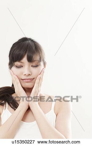 Young Woman Touching Her Cheeks View Large Photo Image Stock Photo - Young Woman Touching Her Cheeks. Fotosearch